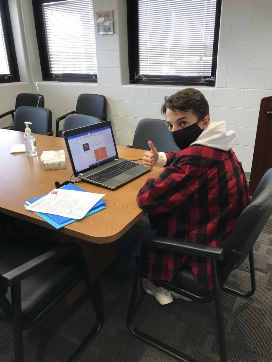 boy at a computer with a thumbs up